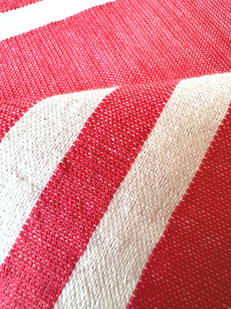 close up on lemlem ayelu fragaria fabric featuring bold two-tone stripe pattern in watermelon pink and soft rosy cream